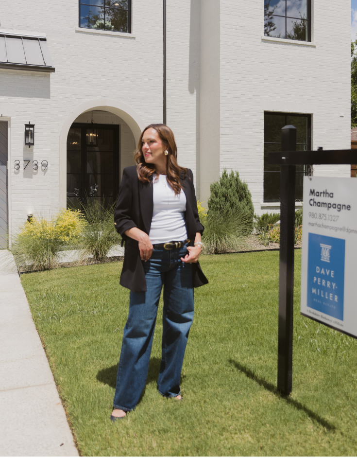 Real estate agent Martha Champagne in front of new construction. Builder Martha Champagne.