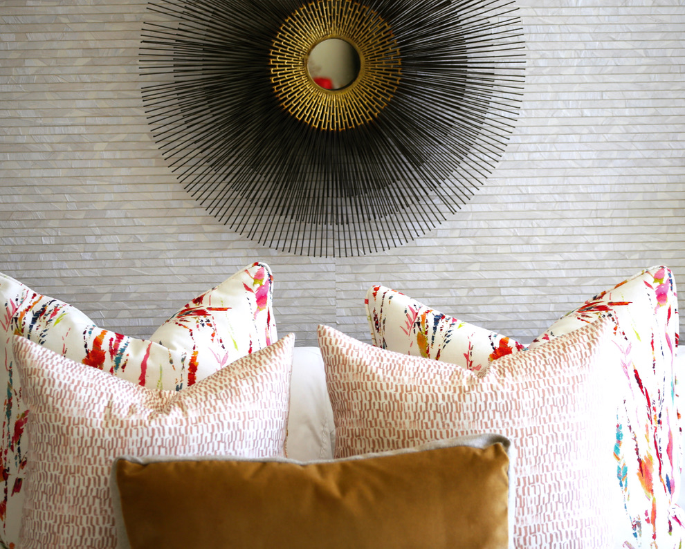 Stylish bedroom decor: sunburst mirror above pillows in VAQUERO ESTATE.