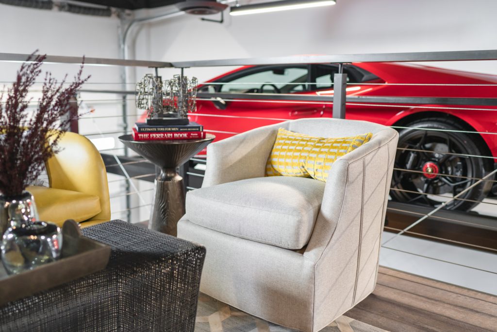 Modern commercial lounge area with seating and a red car in the background.